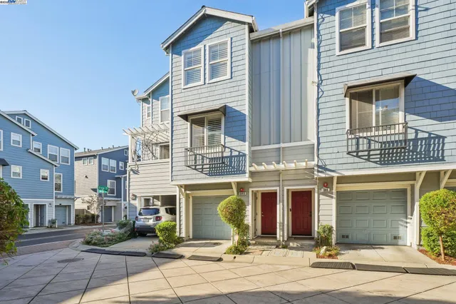 a front view of a house with yard and parking