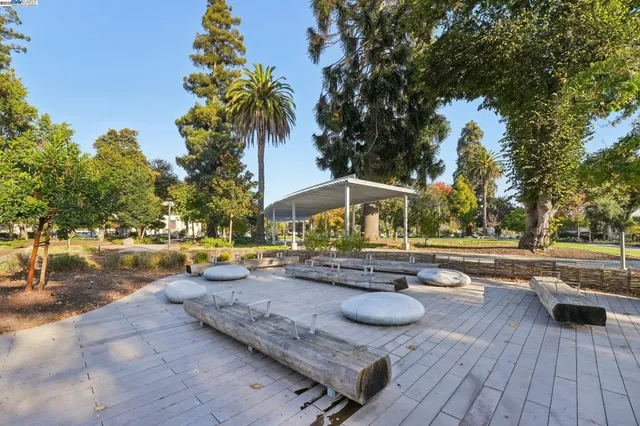 a view of swimming pool with lounge chair and trees