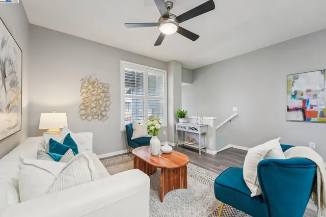 a living room with furniture and a potted plant