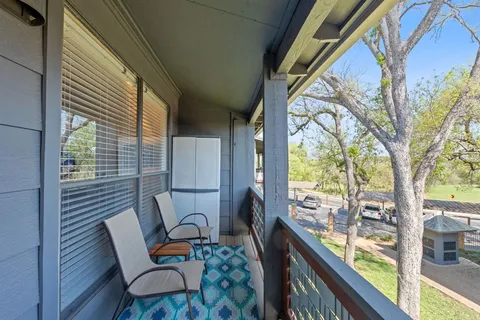 a view of two chairs in the balcony
