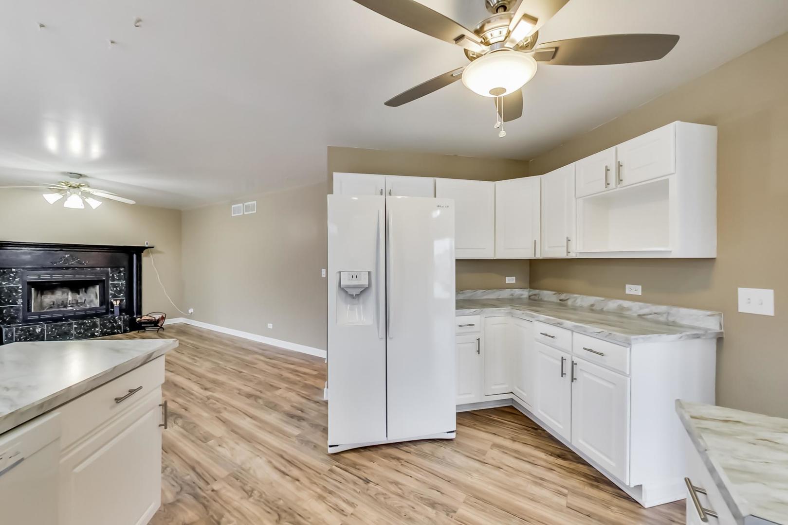 4000 Ridge Road Zion, IL 60099 - Photo 11 of 47 a kitchen with a refrigerator a sink and cabinets