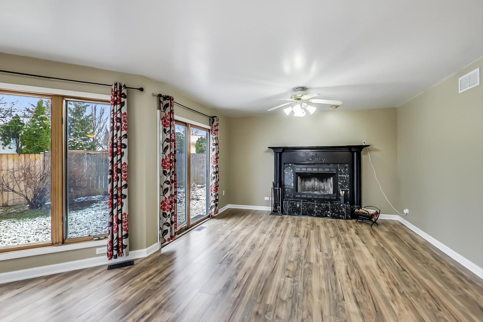 4000 Ridge Road Zion, IL 60099 - Photo 13 of 47 wooden floor in an empty room with a fireplace