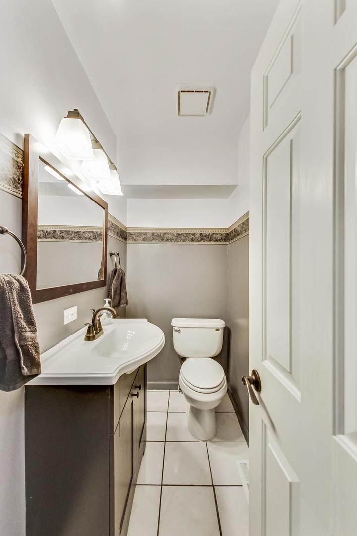 4000 Ridge Road Zion, IL 60099 - Photo 18 of 47 a bathroom with a sink toilet and mirror