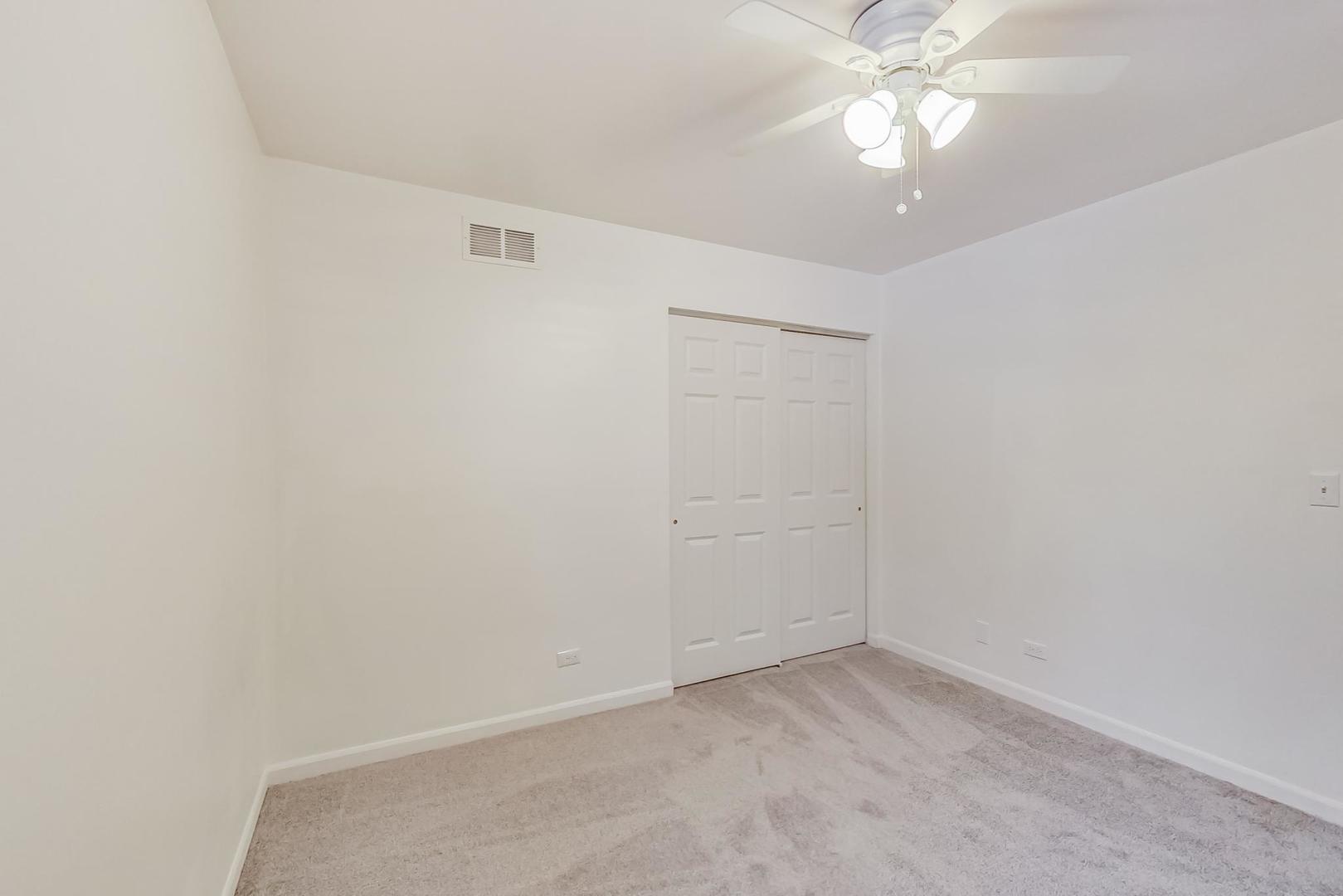 4000 Ridge Road Zion, IL 60099 - Photo 31 of 47 an empty room with a ceiling fan and a window