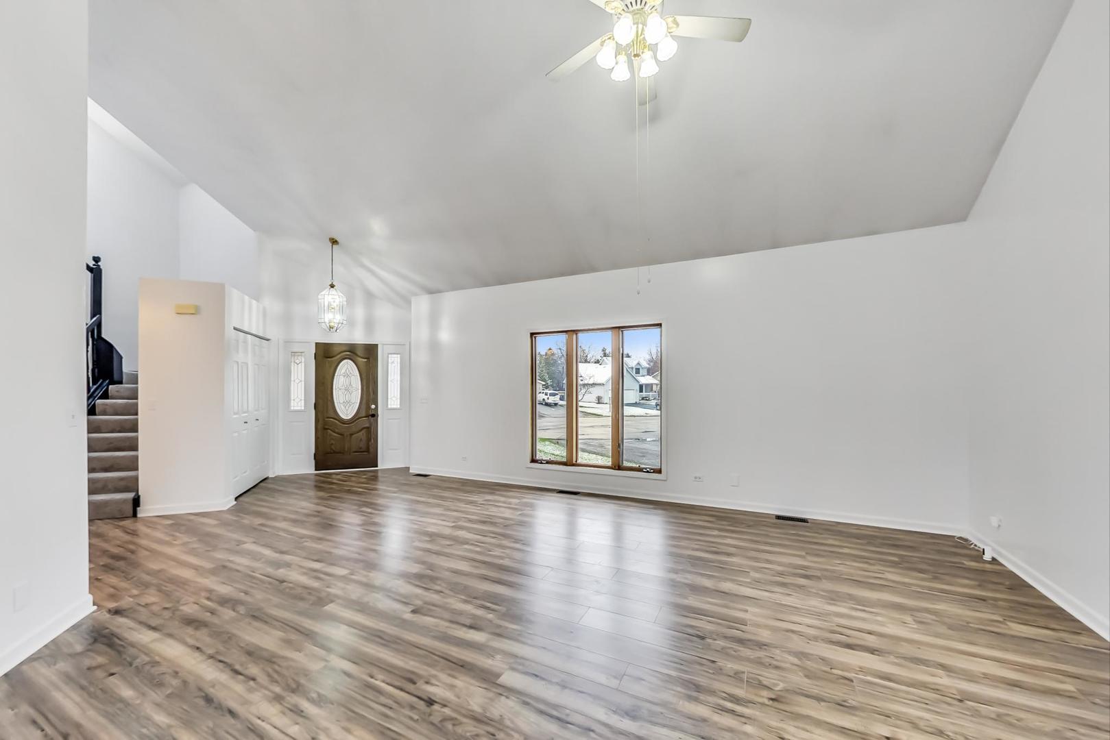 4000 Ridge Road Zion, IL 60099 - Photo 5 of 47 a view of an empty room with a window and wooden floor