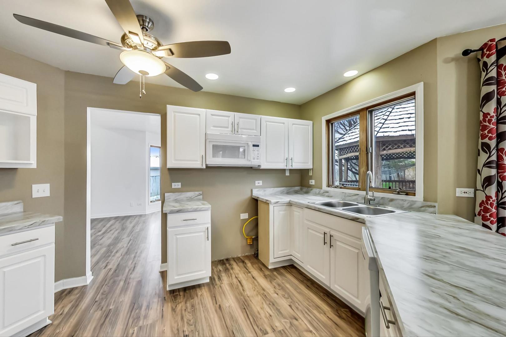 4000 Ridge Road Zion, IL 60099 - Photo 10 of 47 a kitchen with a stove a sink and a refrigerator