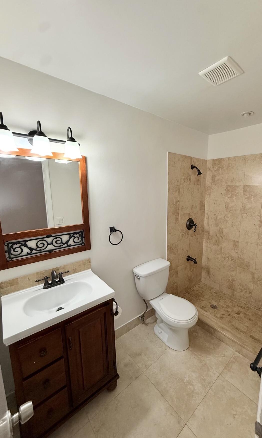 875 Northwest 13th Street, Unit 405 Boca Raton, FL 33486 - Photo 16 of 16 a bathroom with a sink toilet and shower