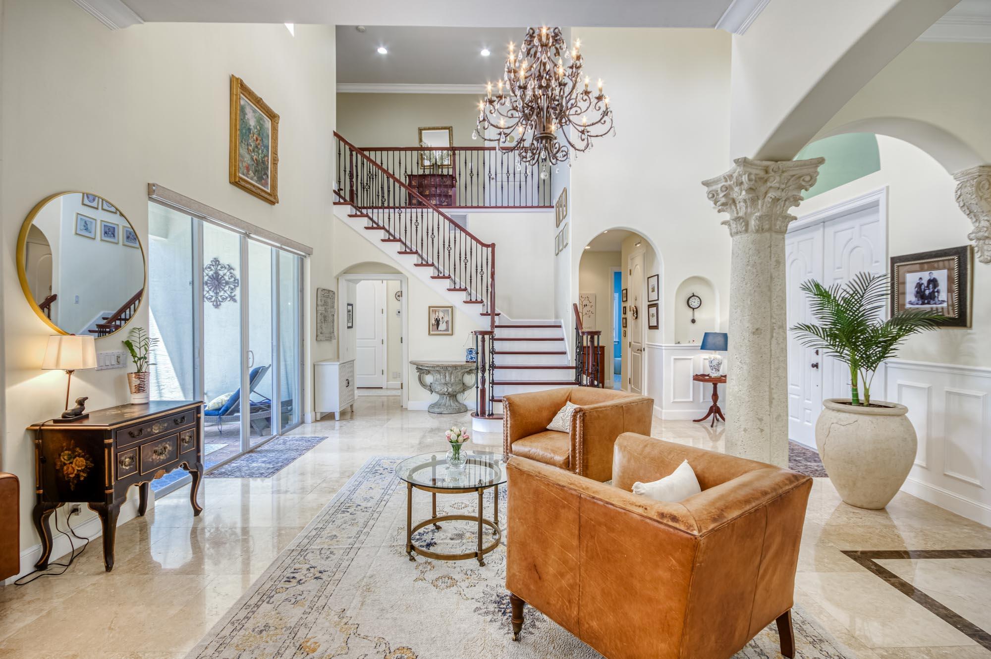 412 Meadowlark Drive Jupiter, FL 33458 - Photo 11 of 40 a living room with furniture a chandelier and a mirror