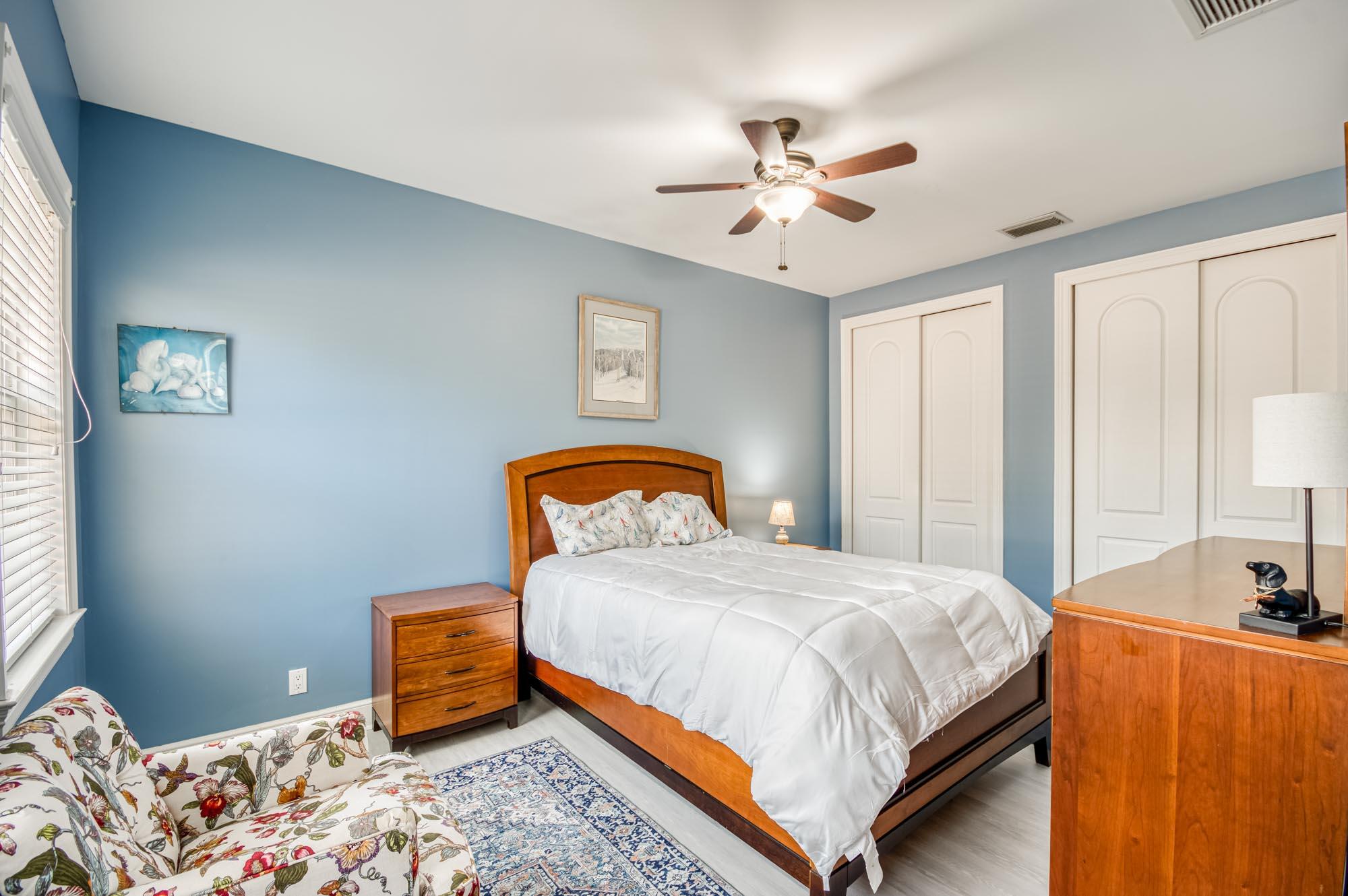 412 Meadowlark Drive Jupiter, FL 33458 - Photo 19 of 40 a bedroom with a bed and a chandelier