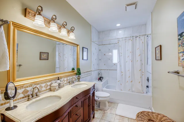a bathroom with a sink mirror toilet and bathtub