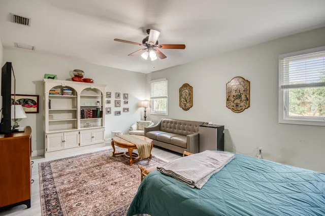 a bedroom with a bed dresser and a window