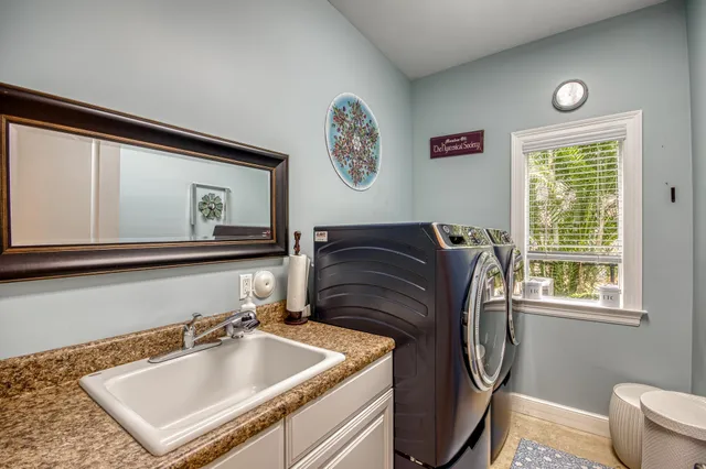 a bathroom with a sink mirror and window