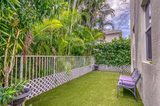 a front view of a house with a yard and green space