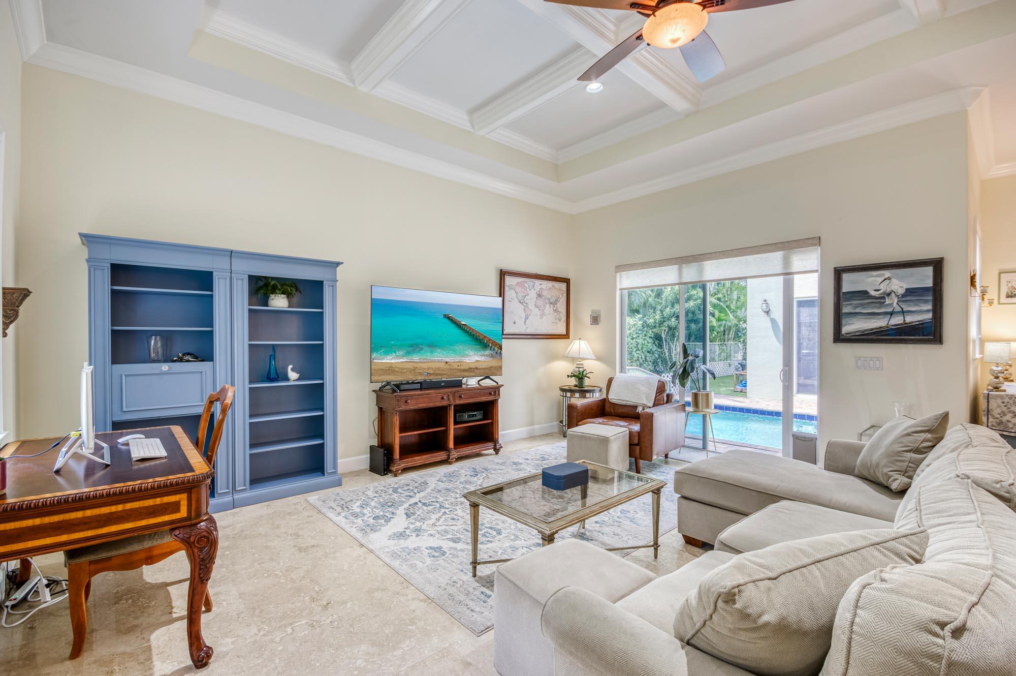 412 Meadowlark Drive Jupiter, FL 33458 - Photo 3 of 40 a living room with furniture a fireplace and a large window