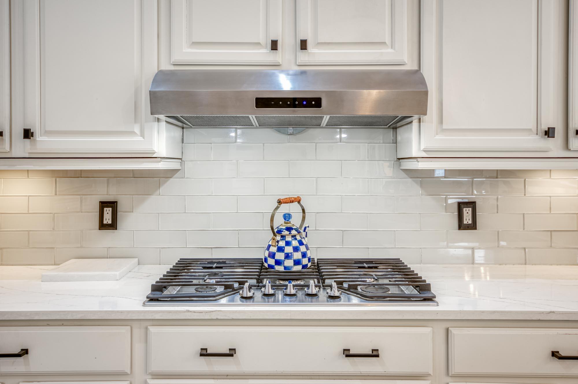 412 Meadowlark Drive Jupiter, FL 33458 - Photo 8 of 40 a kitchen with a stove and cabinets