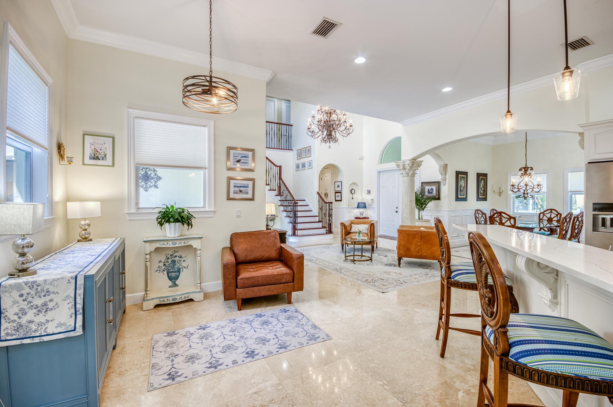 412 Meadowlark Drive Jupiter, FL 33458 - Photo 9 of 40 a living room with fireplace furniture and a chandelier