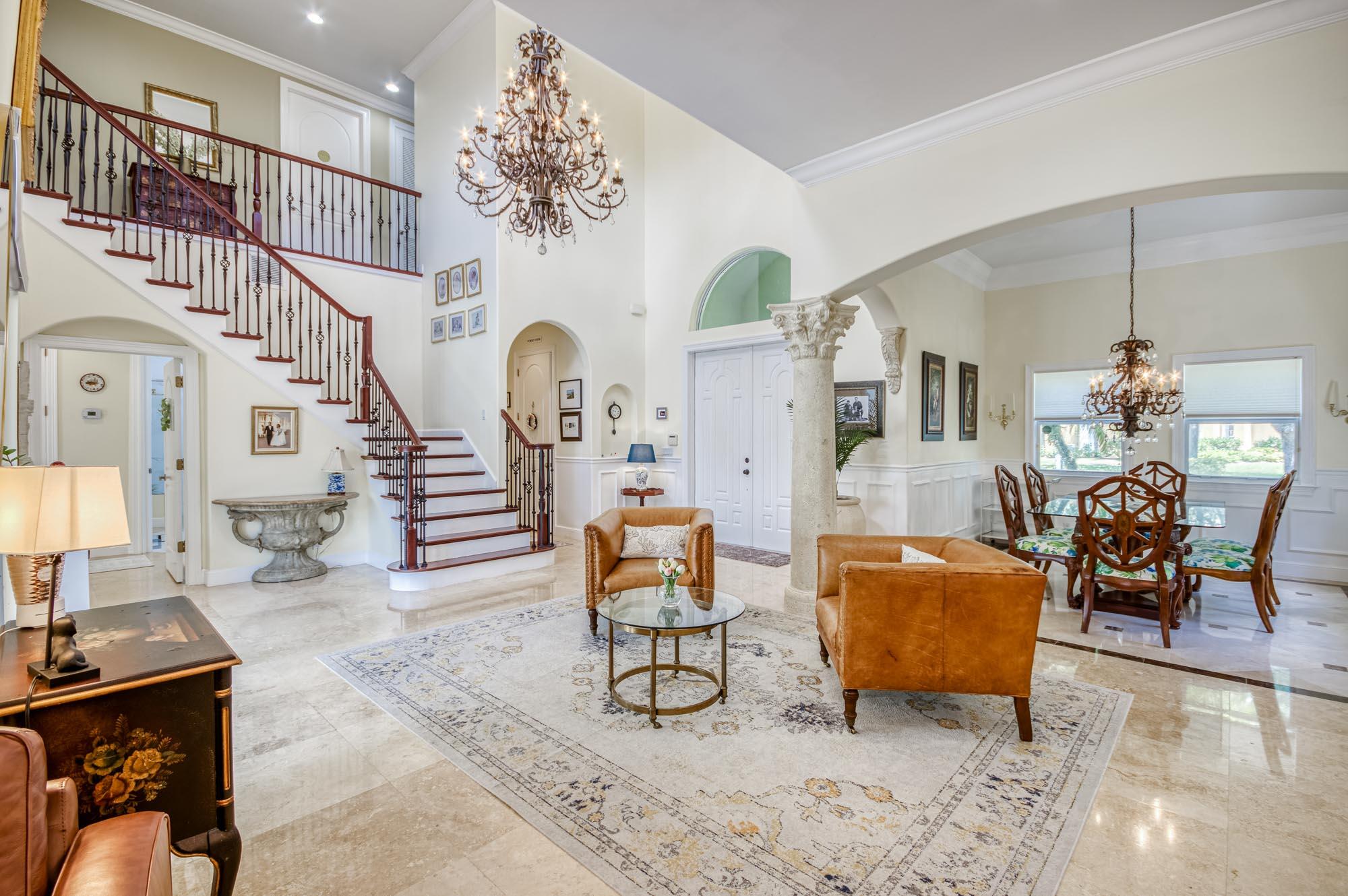 412 Meadowlark Drive Jupiter, FL 33458 - Photo 10 of 40 a living room filled with furniture a chandelier and a dining table
