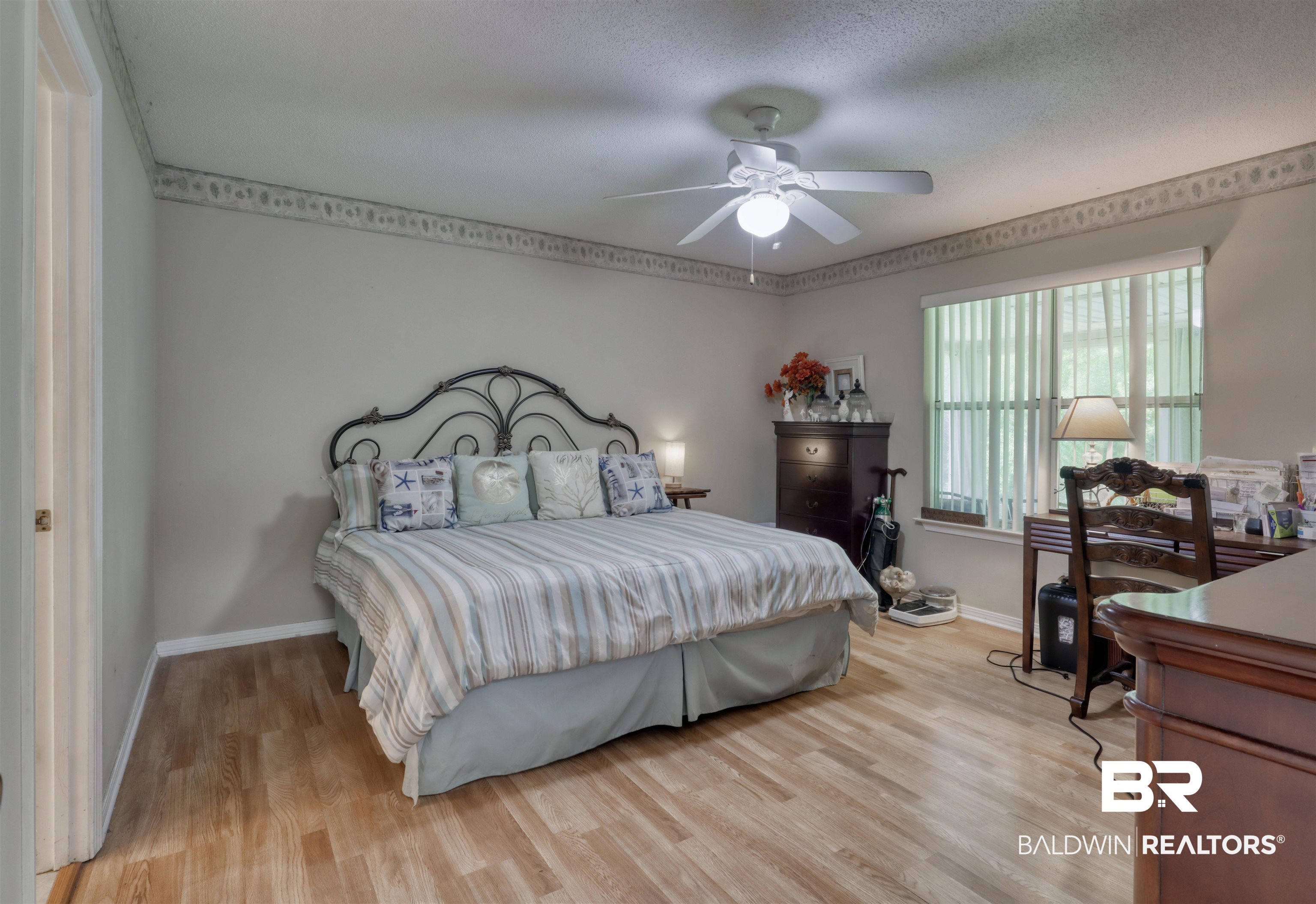 3200 Loop Road, Unit 61 Orange Beach, AL 36561 - Photo 10 of 32 Bedroom featuring light wood-style floors, ceiling fan, and a textured ceiling