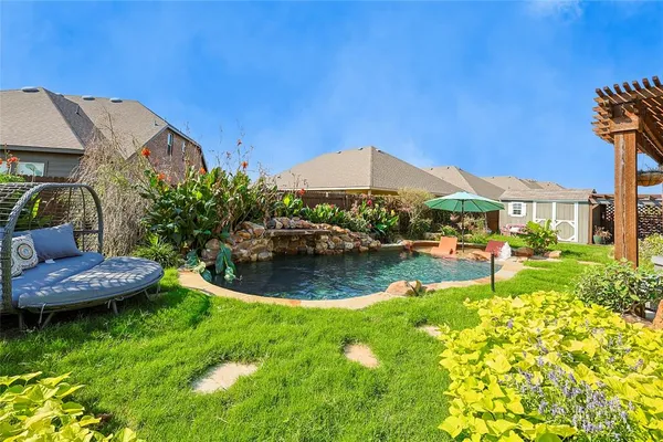 a swimming pool with outdoor seating and yard