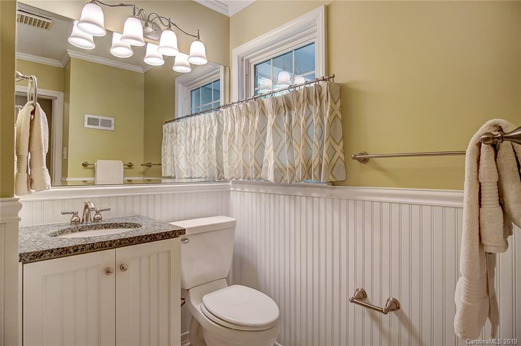 426 Ellsworth Road Charlotte, NC 28211 - Photo 21 of 30 a bathroom with a granite countertop sink vanity mirror and toilet