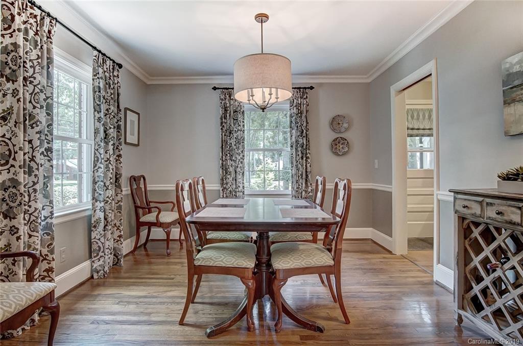 426 Ellsworth Road Charlotte, NC 28211 - Photo 10 of 30 a dining room with furniture a chandelier and wooden floor