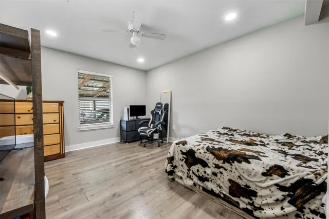 a bedroom with a bed window and flat screen tv