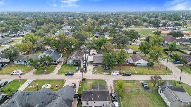 an aerial view of residential houses with outdoor space and river