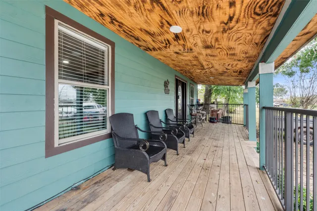 a view of a chairs and table in patio with wooden floor