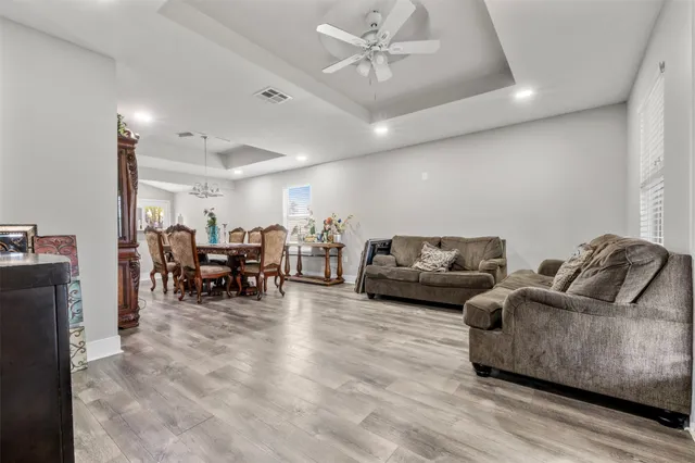a view of a dining room with furniture and wooden floor