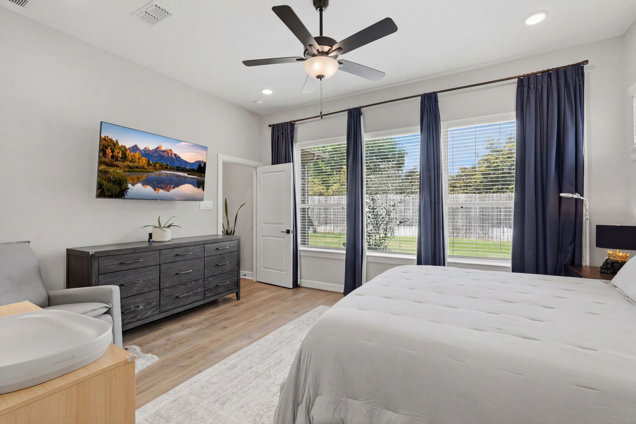 24423 Morningside Terrace Tomball, TX 77375 - Photo 6 of 47 a bedroom with a large bed and a flat screen tv