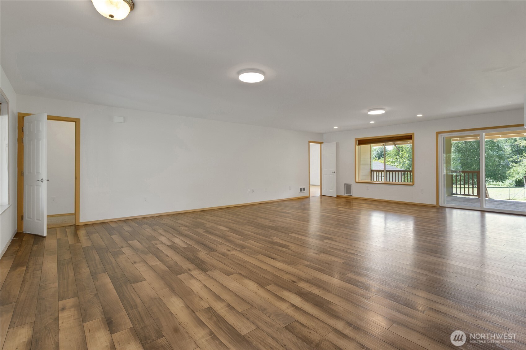 1450 Southeast Spruce Road Port Orchard, WA 98367 - Photo 6 of 39 an empty room with wooden floor and windows