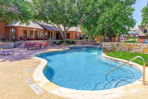 a view of a swimming pool with a patio