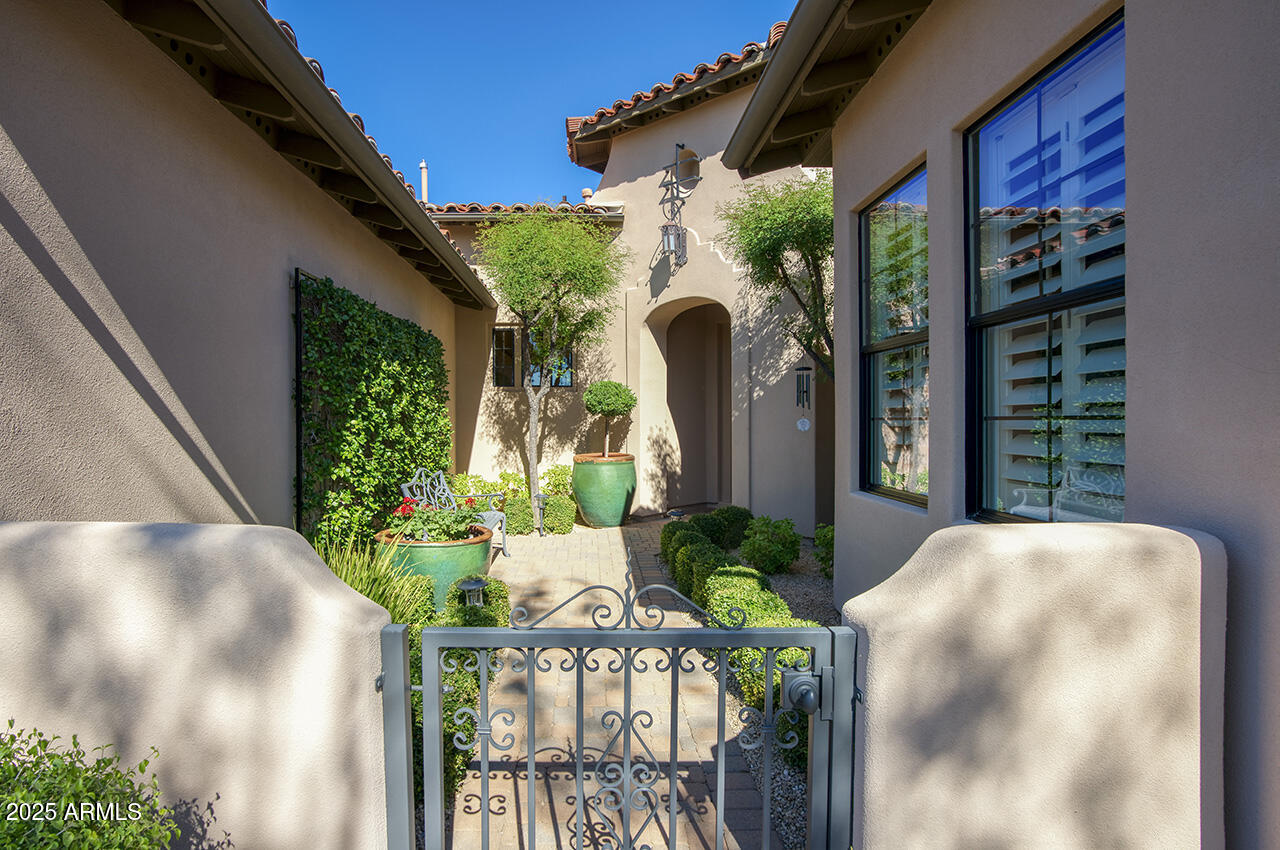 9190 East Hoverland Road Scottsdale, AZ 85255 - Photo 3 of 35 a view of a house with porch and garden
