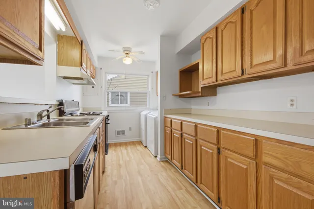 a kitchen with a sink a stove and cabinets