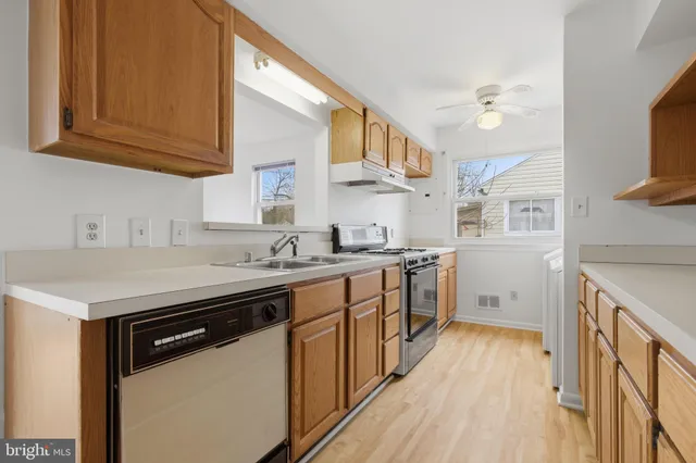 a kitchen with a sink stove and cabinets