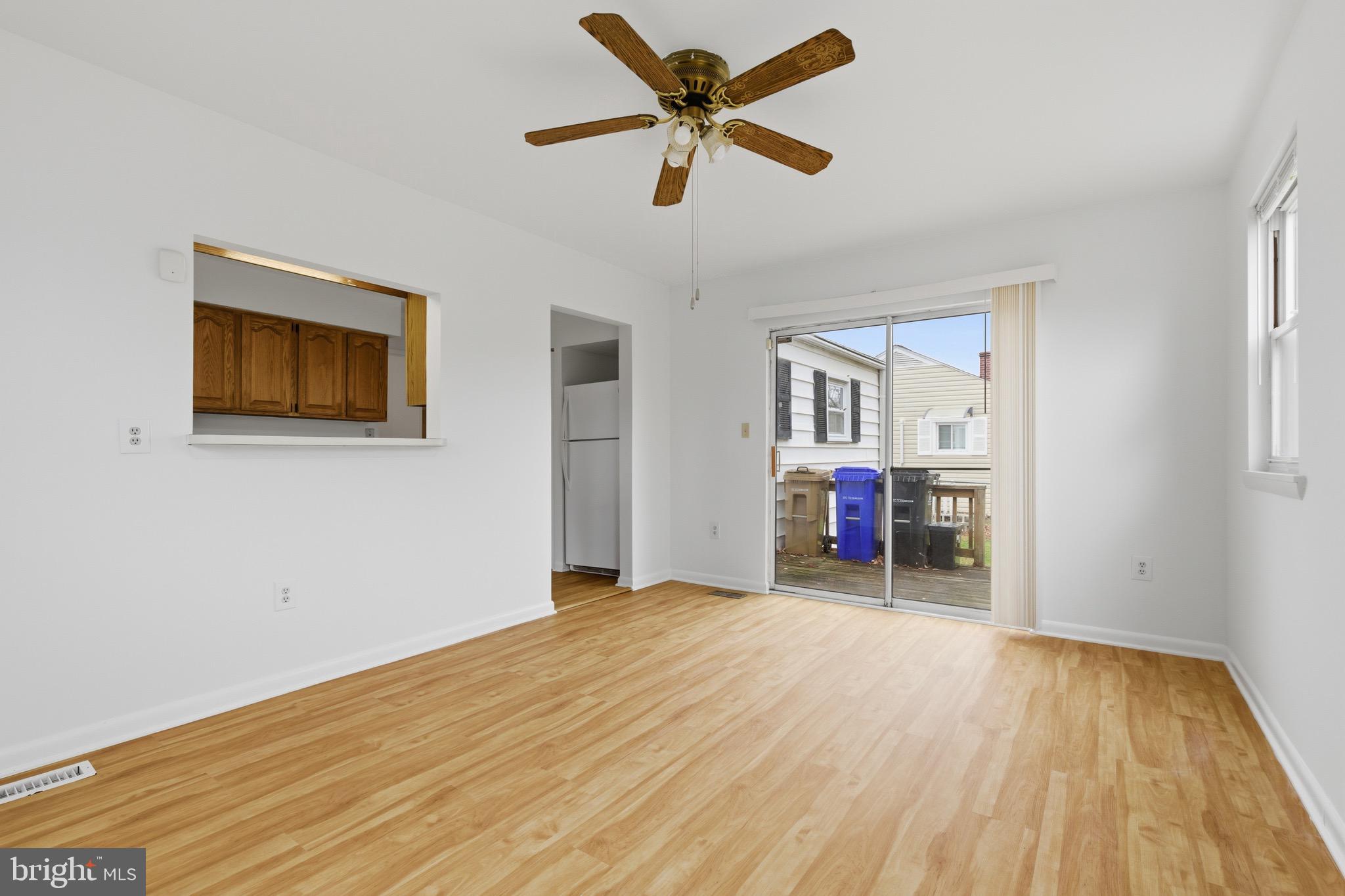1004 Marton Street Laurel, MD 20707 - Photo 19 of 24 a view of a livingroom with wooden floor and a ceiling fan