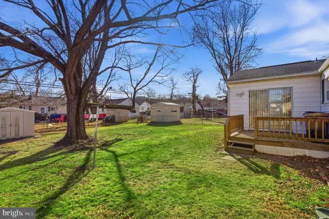 a view of a house with backyard and a tree