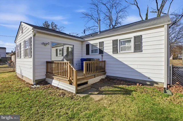 a view of a house with a small yard and wooden fence