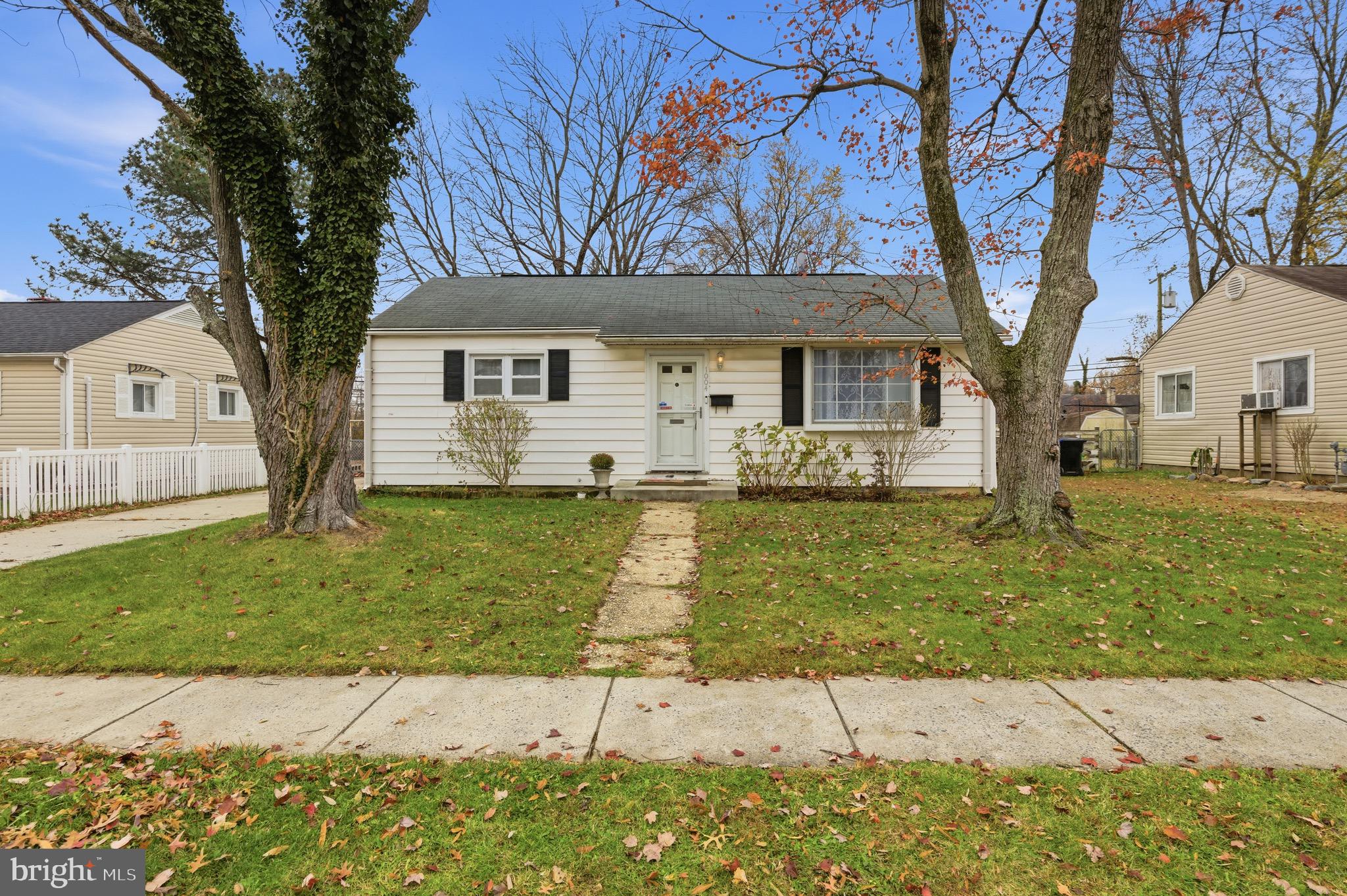 1004 Marton Street Laurel, MD 20707 - Photo 3 of 24 a front view of a house with a garden and trees