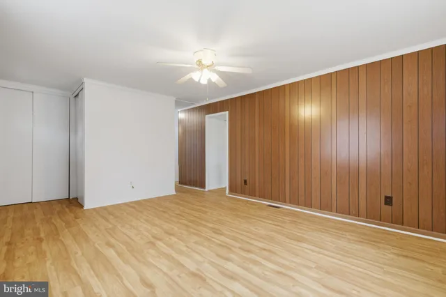 a view of an empty room with wooden floor