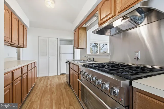 a kitchen with stainless steel appliances granite countertop a stove and a sink