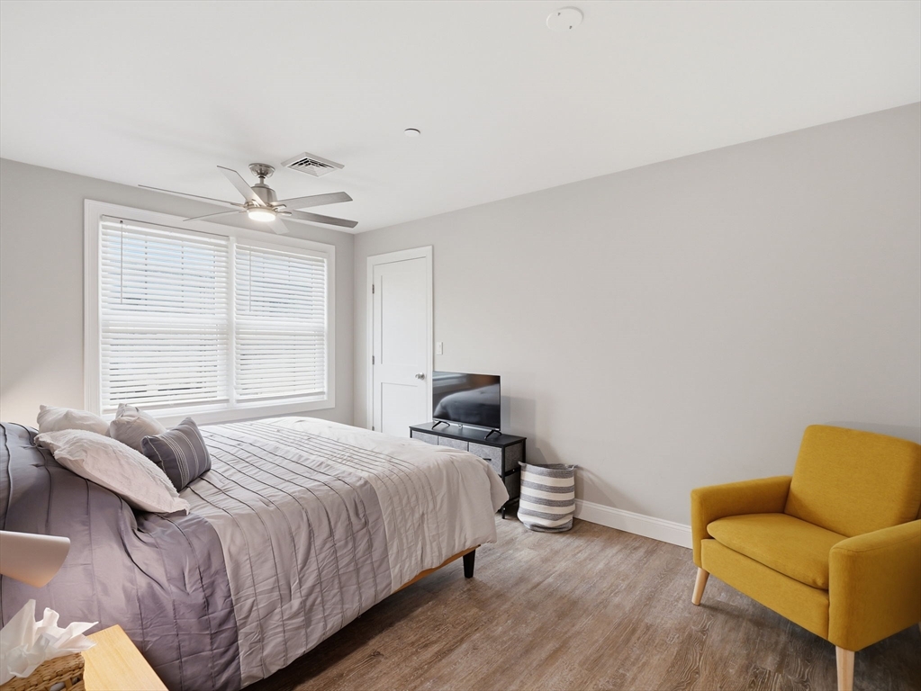 149 Pleasant Street, Unit 2 Marblehead, MA 01945 - Photo 16 of 41 a bedroom with a bed couch and window