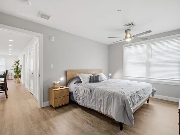 a bedroom with a bed and a large window