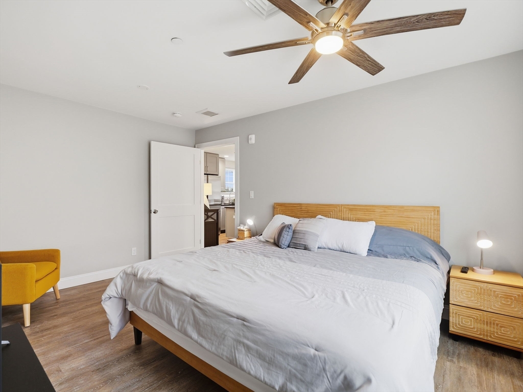 149 Pleasant Street, Unit 2 Marblehead, MA 01945 - Photo 18 of 41 a bedroom with a bed and a chandelier