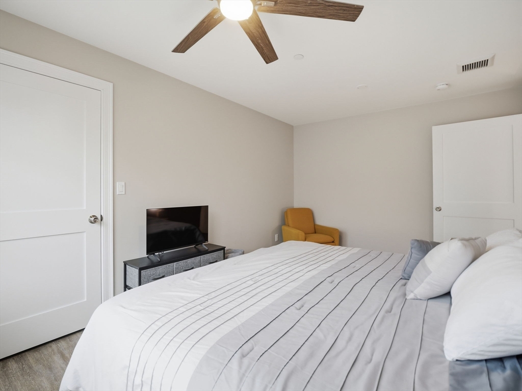 149 Pleasant Street, Unit 2 Marblehead, MA 01945 - Photo 19 of 41 a bedroom with a bed and a tv