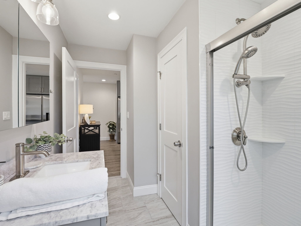 149 Pleasant Street, Unit 2 Marblehead, MA 01945 - Photo 22 of 41 a bathroom with a sink vanity mirror and shower