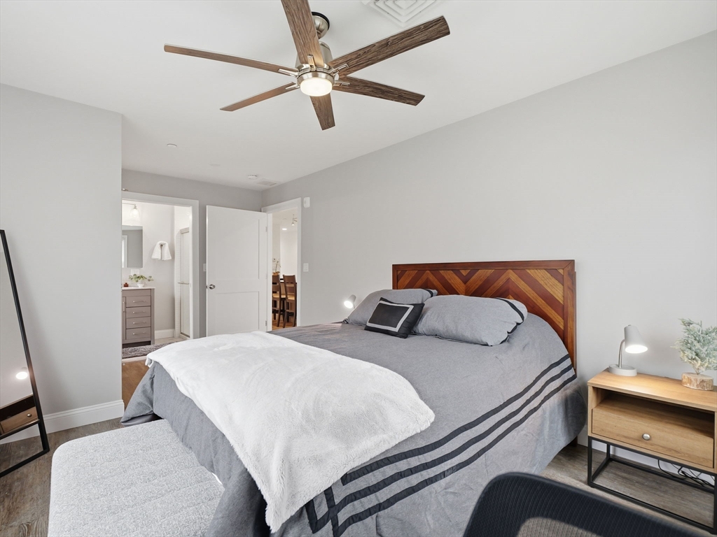 149 Pleasant Street, Unit 2 Marblehead, MA 01945 - Photo 24 of 41 a bedroom with a bed and a chandelier