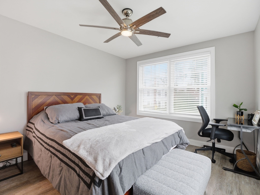 149 Pleasant Street, Unit 2 Marblehead, MA 01945 - Photo 25 of 41 a bedroom with a bed a couch and a large window