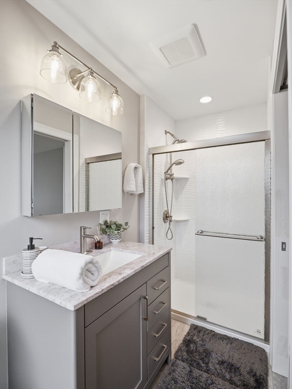 149 Pleasant Street, Unit 2 Marblehead, MA 01945 - Photo 29 of 41 a bathroom with a sink a mirror and a shower