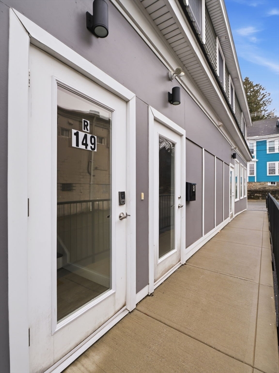 149 Pleasant Street, Unit 2 Marblehead, MA 01945 - Photo 30 of 41 a view of a hallway with a glass door